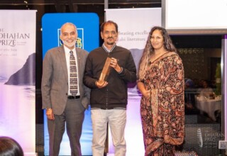 Barj S. Dhahan, Dhahan Prize Founder, Jinder and Kiran Sunar, Acting Assistant Professor of Punjabi Language, Literature, and Culture, Department of Asian Studies, University of British Columbia (UBC) Jinder - Dhahan Prize Winner 2024 with trophy on stage