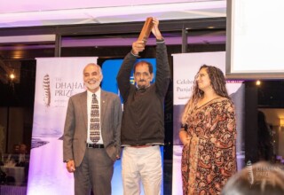 Barj S. Dhahan, Dhahan Prize Founder, Jinder and Kiran Sunar, Acting Assistant Professor of Punjabi Language, Literature, and Culture, Department of Asian Studies, University of British Columbia (UBC) Jinder - Dhahan Prize Winner 2024 with trophy on stage