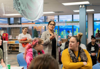 Gurpreet Bains, Languages Department Head at L.A. Matheson Secondary School, Surrey, British Columbia, Nov. 15, 2022 Teacher Gurpreet Bains speaking to audience of students at presentation with award winning Punjabi author